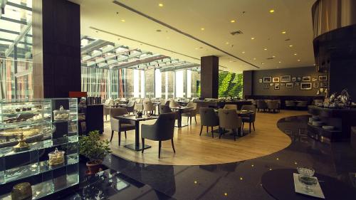 a restaurant with tables and chairs in a building at The Oterra in Bengaluru