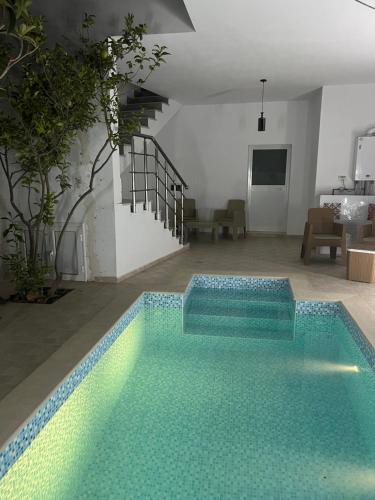 a swimming pool in the middle of a living room at EVA'S HOME in Bizerte