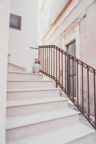 a set of stairs in a white building at Casa Vacanza Stomar in Pozzallo