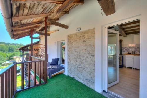 a home with a balcony with green carpet at Country Side Of Lake Maggiore - Happy Rentals in Brovello-Carpugnino