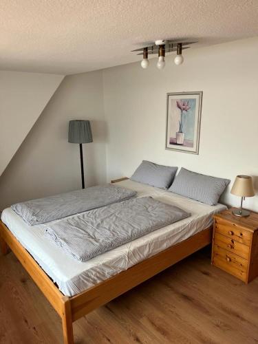 a bedroom with a large bed and a night stand at Nord Haus in Kiel