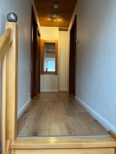 an empty room with a hallway with wooden floors at Nord Haus in Kiel