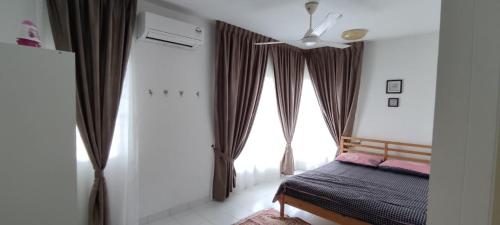 a bedroom with a bed and a large window at Al Fateh Homestay Apartment in Putrajaya in Putrajaya