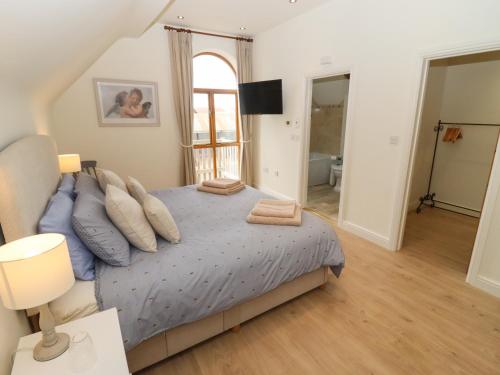 a bedroom with a bed with pillows on it at The Granary at Lane End Farm in Evesham
