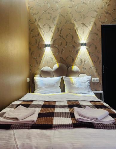 a bedroom with a bed with two towels on it at Sunny guesthouse in Stepantsminda