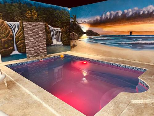 a swimming pool in a room with a painting on the wall at Complejo Giraflor in Pantoja