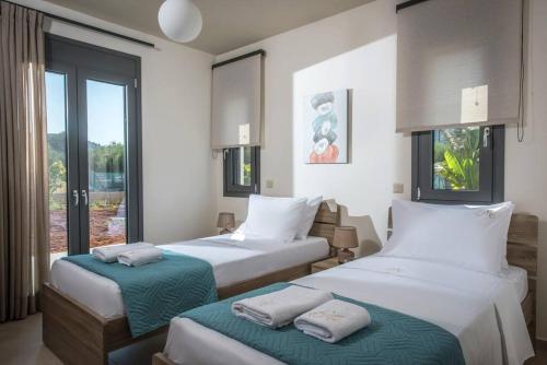 Katil atau katil-katil dalam bilik di Malena Residence by 8essentially