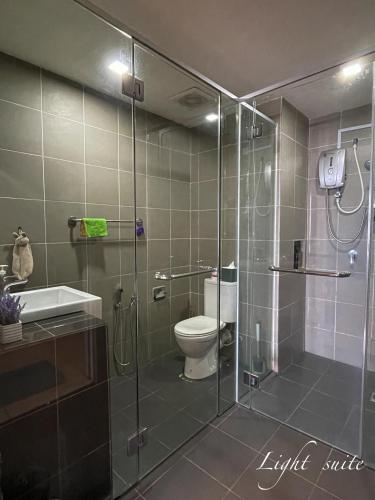 a bathroom with a shower with a toilet and a sink at Chill Studio Wi-Fi & Netflix 5min From Airport At Aeropod Sovo in Kota Kinabalu