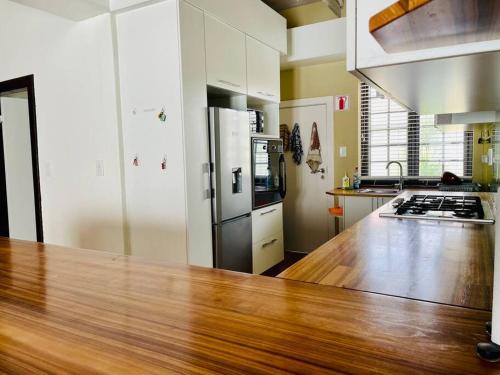 a kitchen with a wooden counter top and a refrigerator at 3 Bedroom, 3 Bathroom, Close to the Beach & Town in Swakopmund