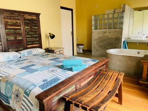 a bedroom with a tub and a bed with a bench at 3 Bedroom, 3 Bathroom, Close to the Beach & Town in Swakopmund