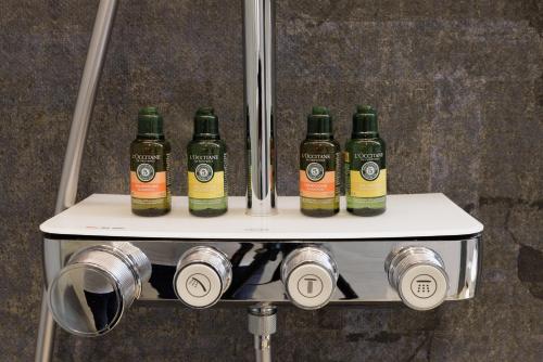 a group of four bottles of alcohol on a shelf at Darovanský Dvůr - Wellness & Golf Hotel in Břasy