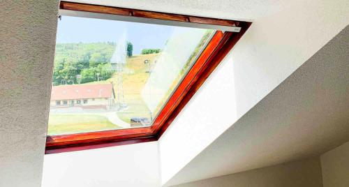 a window in a room with a view of a house at Jahodná in Košice