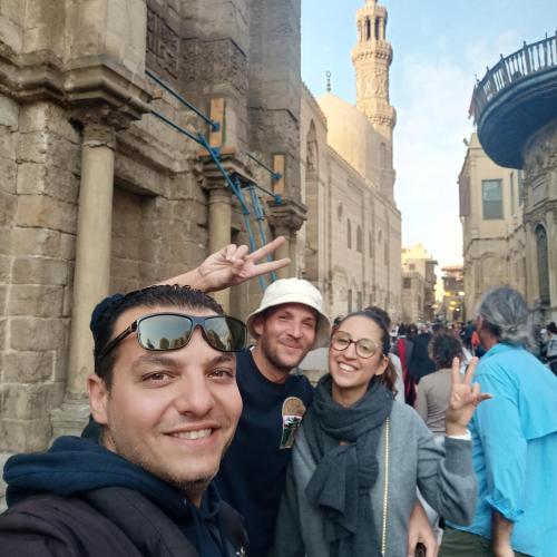 a group of people standing in front of a building at Sooly pyramids Inn in Cairo