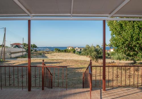 a view of a field from a balcony at Shoreline Drive Beach House in Makris Gialos