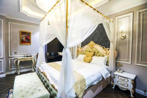 a bedroom with a bed with a canopy at ENJOY HOTEL 2 in Ho Chi Minh City