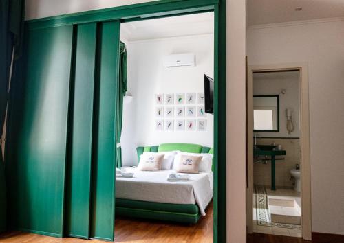 a bedroom with a bed and a green glass door at Residenza Romana in Rome