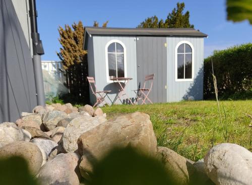 a pile of rocks in front of a shed at CosyPlace; close to beach, nature, train, grocery in Köpingebro