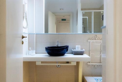 a bathroom with a sink and a mirror at Residenza Romana in Rome