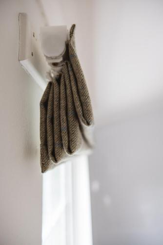 a pair of gloves hanging from a towel rack at Greshornish House Hotel in Edinbane