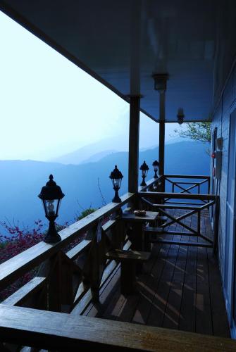 a porch of a house with a view of the mountains at Emmanuel Farm House in Renai