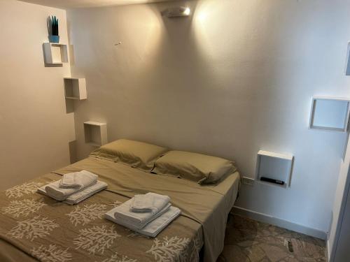 a bedroom with a bed with two towels on it at La casa di Ginevra in Polignano a Mare