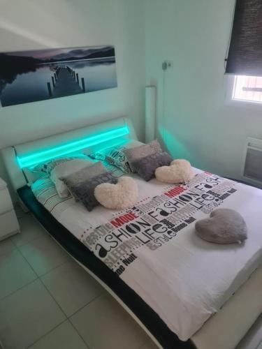 a bed with a light on top of it at Chez Riz in Arles