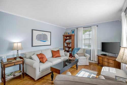 a living room with a couch and a tv at Neighborhood Retreat, Large Yard Family in Nashville