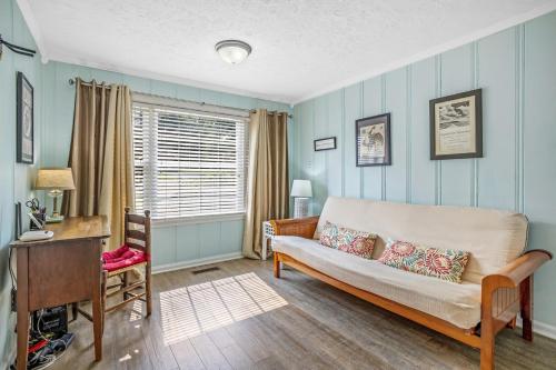 a living room with a couch and a desk at Neighborhood Retreat, Large Yard Family in Nashville