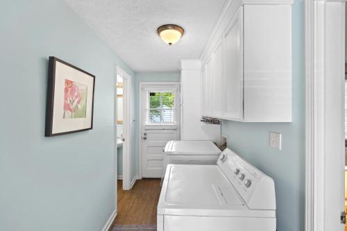 a kitchen with a white washer and dryer in it at Neighborhood Retreat, Large Yard, Fire Pit in Nashville