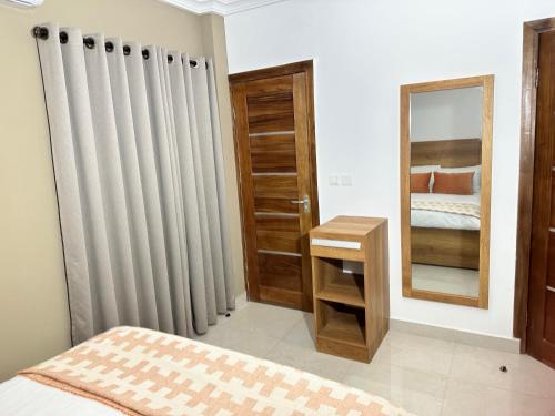 a bedroom with a radiator and a mirror at Westlands Tower - Ghana Villas in Accra