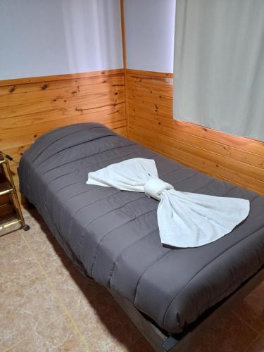 a bed with two white towels on top of it at Los Nopo in Trevelin