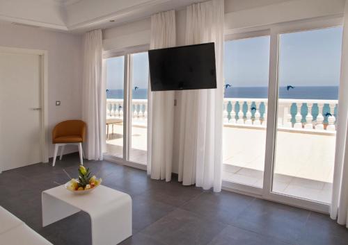 a living room with a view of the ocean at Hotel Los Delfines in La Manga del Mar Menor