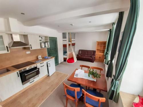 a kitchen and living room with a table and chairs at Studio Vodopády Černá Desná by Interhome in Desná