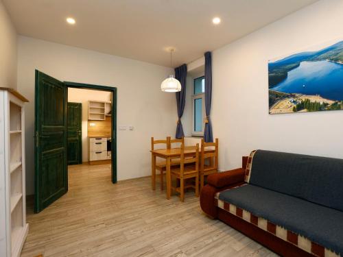 a living room with a couch and a table at Apartment Přehrada Souš by Interhome in Desná