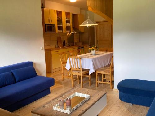 ein Wohnzimmer mit einem blauen Sofa und einem Tisch in der Unterkunft Apartment Hasenstall - Top 8 by Interhome in Grünau im Almtal