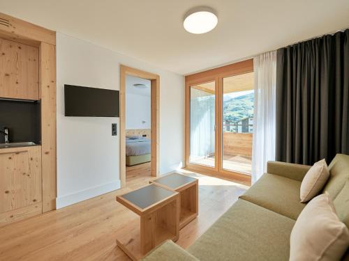 sala de estar con sofá y ventana grande en Apartment Catrina Experience-1 by Interhome, en Disentis