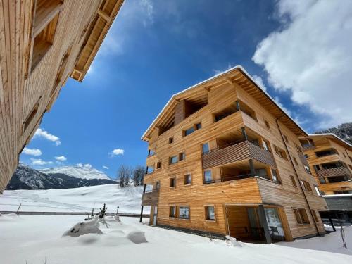 a large wooden building in the snow at Apartment Catrina 3-Zimmer Premium Apartment by Interhome in Disentis