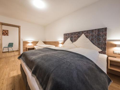 1 dormitorio con 1 cama grande con manta negra en Apartment Montec-3 by Interhome, en Hippach