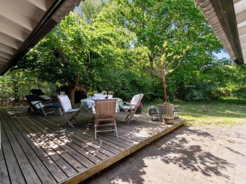 a patio with a table and chairs on a deck at Holiday Home Bistra - 280m from the sea in Sealand by Interhome in Vejby