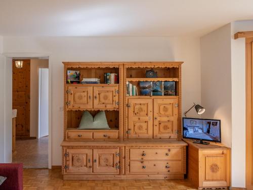 a large wooden cabinet in the corner of a room at Apartment Chesa Muntarütsch by Interhome in Samedan