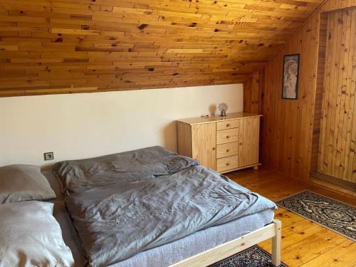 a bedroom with a bed and a wooden ceiling at Holiday Home Jaruška by Interhome 