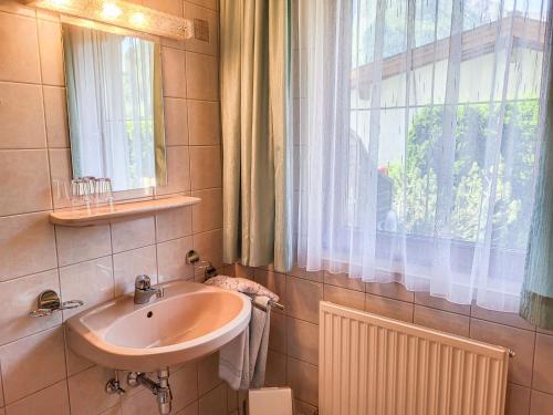 a bathroom with a sink and a window at Apartment Sonnenschein B by Interhome in Spiss
