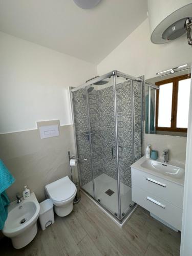 a bathroom with a shower and a toilet and a sink at Villa delle Ninfee in Gela