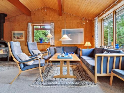 a living room with a couch and chairs and a table at Holiday Home Nada - 200m from the sea in Bornholm by Interhome in Vester Sømarken