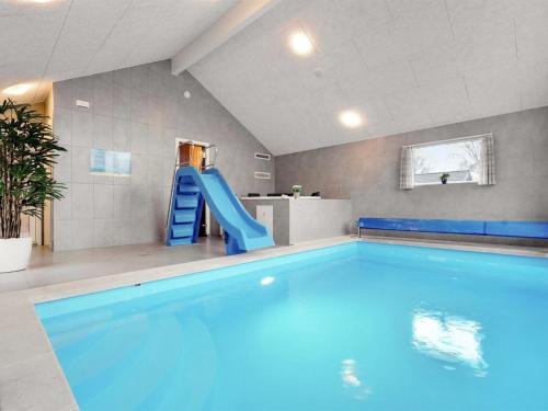 - une piscine avec toboggan bleu dans une chambre dans l'établissement Holiday Home Ursel - all inclusive - 600m from the sea by Interhome, à Stege