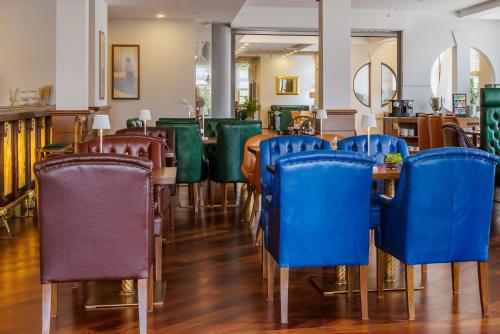a row of chairs and tables in a restaurant at Darovanský Dvůr - Wellness & Golf Hotel in Břasy