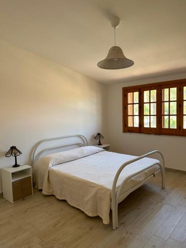 a bedroom with a bed and two lamps on tables at Villa delle Ninfee in Gela