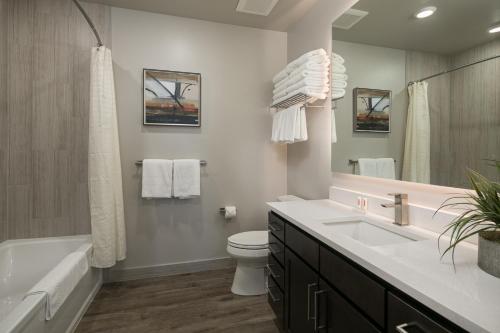 a bathroom with a tub and a toilet and a sink at Sage Creek at Moab Luxury Condo B in Moab