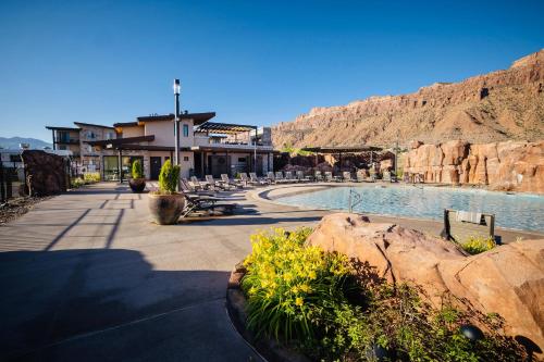 a resort with a swimming pool and a mountain at Sage Creek at Moab Luxury Condo B in Moab