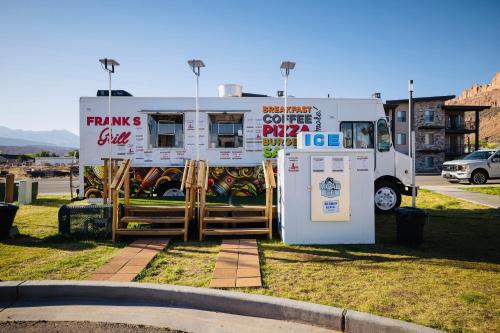 a food truck parked in a parking lot next to a building at Sage Creek at Moab Luxury Condo B in Moab